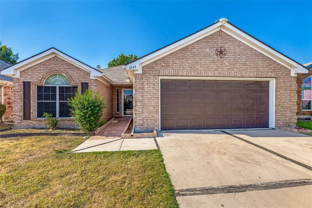 4545 Grainland Court, Fort Worth, TX 76179 Brick exterior with a prominent arched window and dark shutters