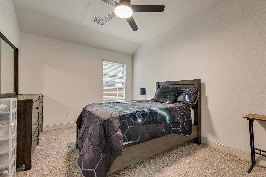 107 White Sands Lane, Forney, TX 75126 Carpeted bedroom with a ceiling fan and light fixture, a window with blinds, and light-toned wall paint