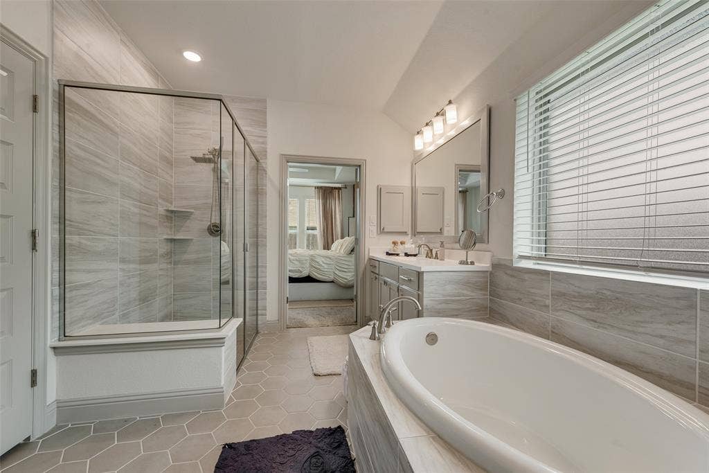 107 White Sands Lane, Forney, TX 75126 Glass-enclosed tiled shower and a separate soaking tub in the primary bathroom