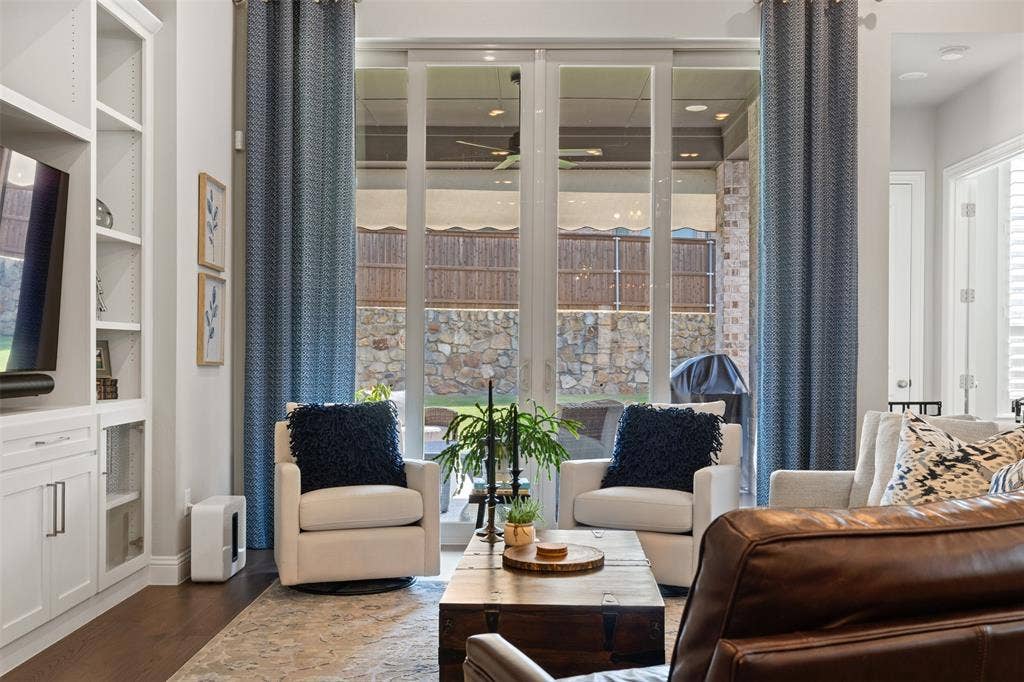 9716 Wilderness Road, Little Elm, TX 75068 Living room with integrated built-in cabinetry, wood-finish flooring, recessed lighting, and large sliding glass doors