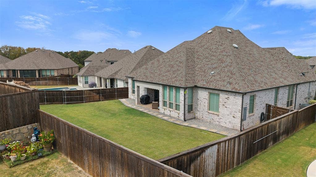 9716 Wilderness Road, Little Elm, TX 75068 Private fenced backyard with a manicured lawn, stone paver cover patio