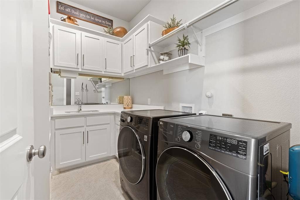 9716 Wilderness Road, Little Elm, TX 75068 Laundry room with sink and built-in cabinets