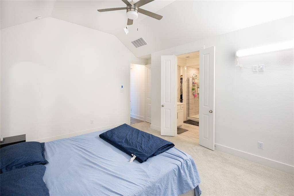 3017 Andorra Road, McKinney, TX 75071 Vaulted ceiling with a ceiling fan, light-toned carpeting, white walls, and white trim