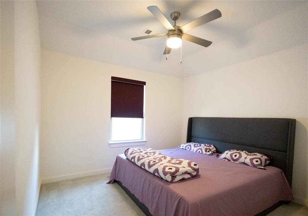 3017 Andorra Road, McKinney, TX 75071 Recessed window with privacy roller shade, ceiling fan with integrated lighting, and carpeted flooring