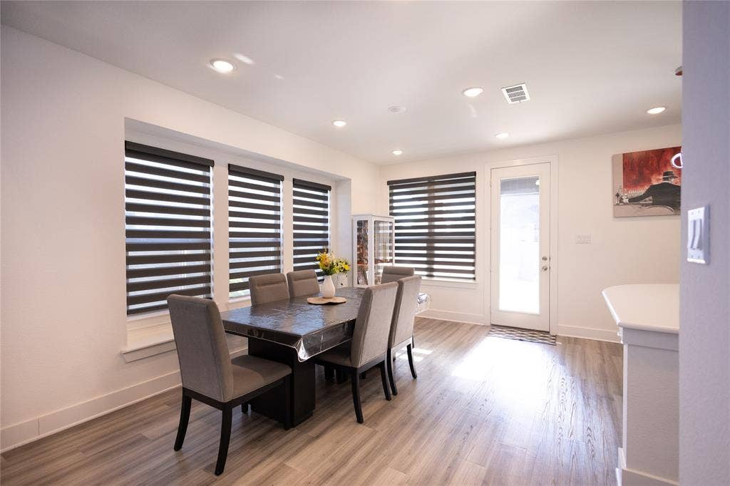 3017 Andorra Road, McKinney, TX 75071 Recessed ceiling lighting, wood-finish flooring, white trim, multiple windows with blinds, and a glass-paneled door