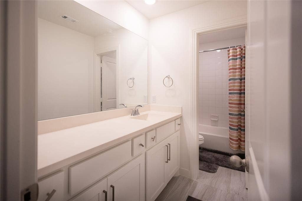 3017 Andorra Road, McKinney, TX 75071 Vanity with integrated sink, contemporary chrome faucet, and white cabinetry