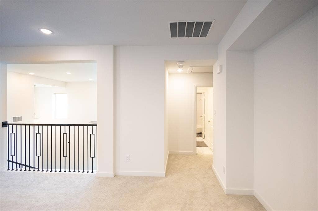 3017 Andorra Road, McKinney, TX 75071 Carpeted hallway with recessed lighting and a black iron railing, complemented by white walls and trim