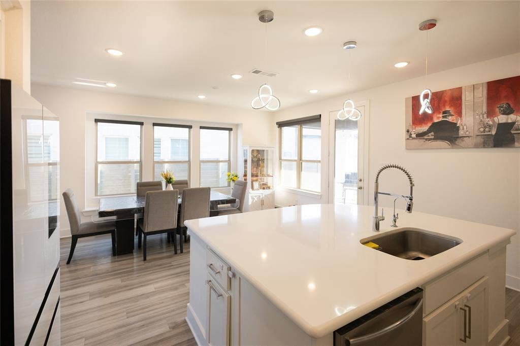 3017 Andorra Road, McKinney, TX 75071 Kitchen island with a stainless steel sink and a pull-down faucet