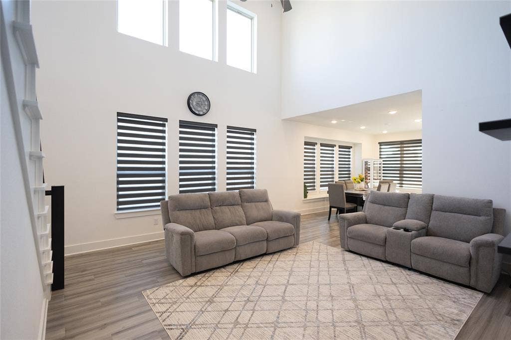 3017 Andorra Road, McKinney, TX 75071 High ceilings with upper windows, wood-finish flooring, and integrated window treatments