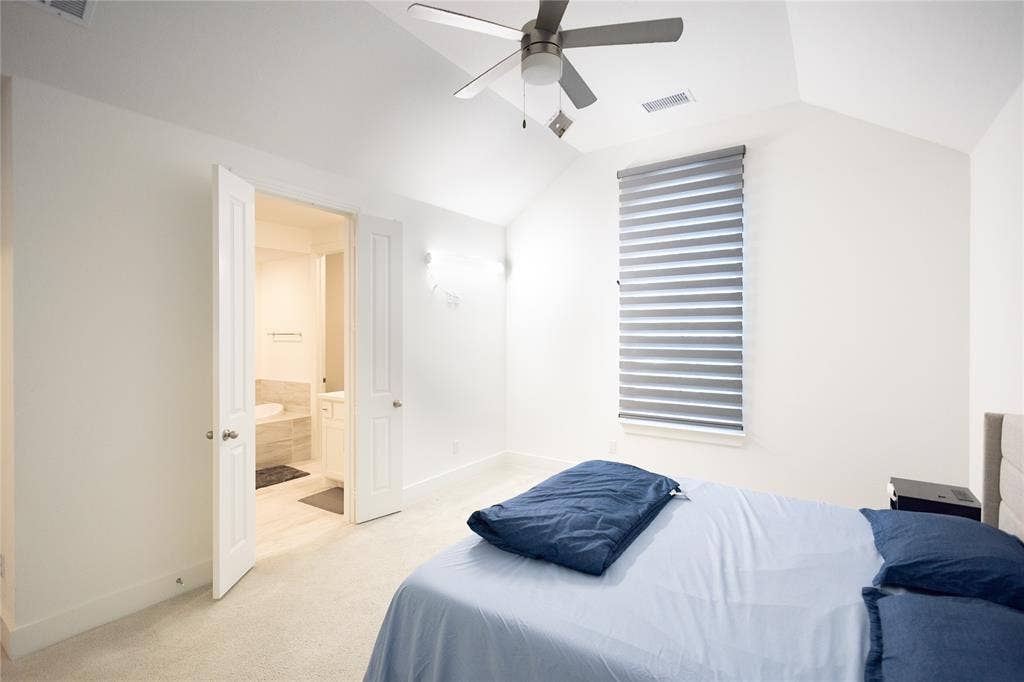 3017 Andorra Road, McKinney, TX 75071 Vaulted ceiling with a ceiling fan, window with privacy blinds, and light-colored carpet flooring