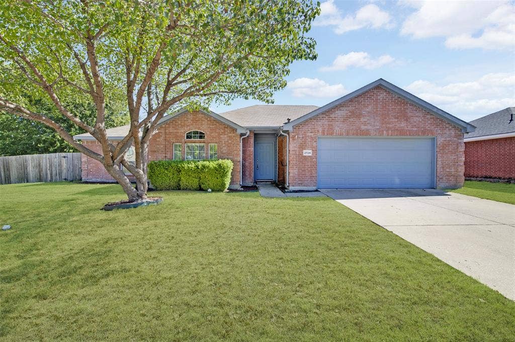 2724 Douglas Drive, McKinney, TX 75071 Brick exterior with a gabled roofline, attached garage, large front lawn area, and established tree