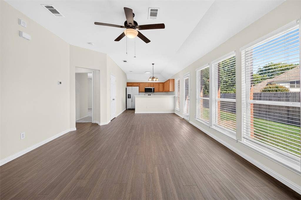 2724 Douglas Drive, McKinney, TX 75071 Open-concept living, dining space featuring wood-finish flooring, a ceiling fan, and multiple windows