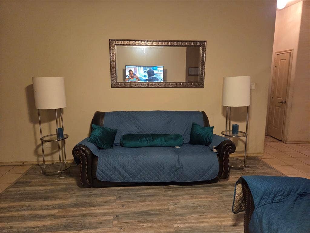 1026 Rio Vista Drive, DeSoto, TX 75115 Wood-finish flooring throughout, complemented by a decorative wall mirror