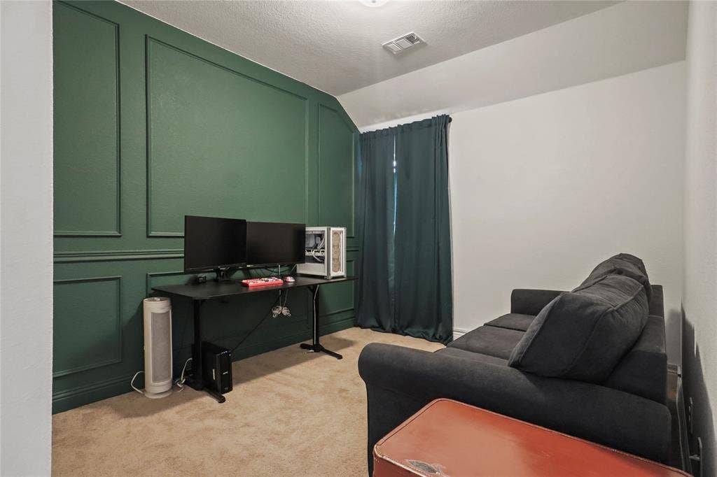 6152 Cobbetts Pond Lane, Fort Worth, TX 76179 Accent wall with applied molding, wall-to-wall carpeting, and window with dark drapery