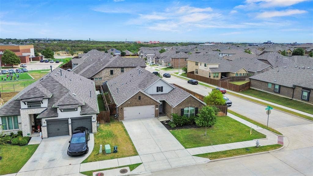 6152 Cobbetts Pond Lane, Fort Worth, TX 76179 Suburban residential setting featuring single-family homes with pitched shingle roofs and integrated garages