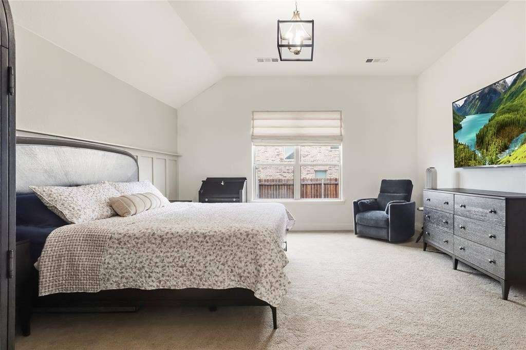 6152 Cobbetts Pond Lane, Fort Worth, TX 76179 Vaulted ceiling with an overhead light fixture, carpeted flooring, and a large window