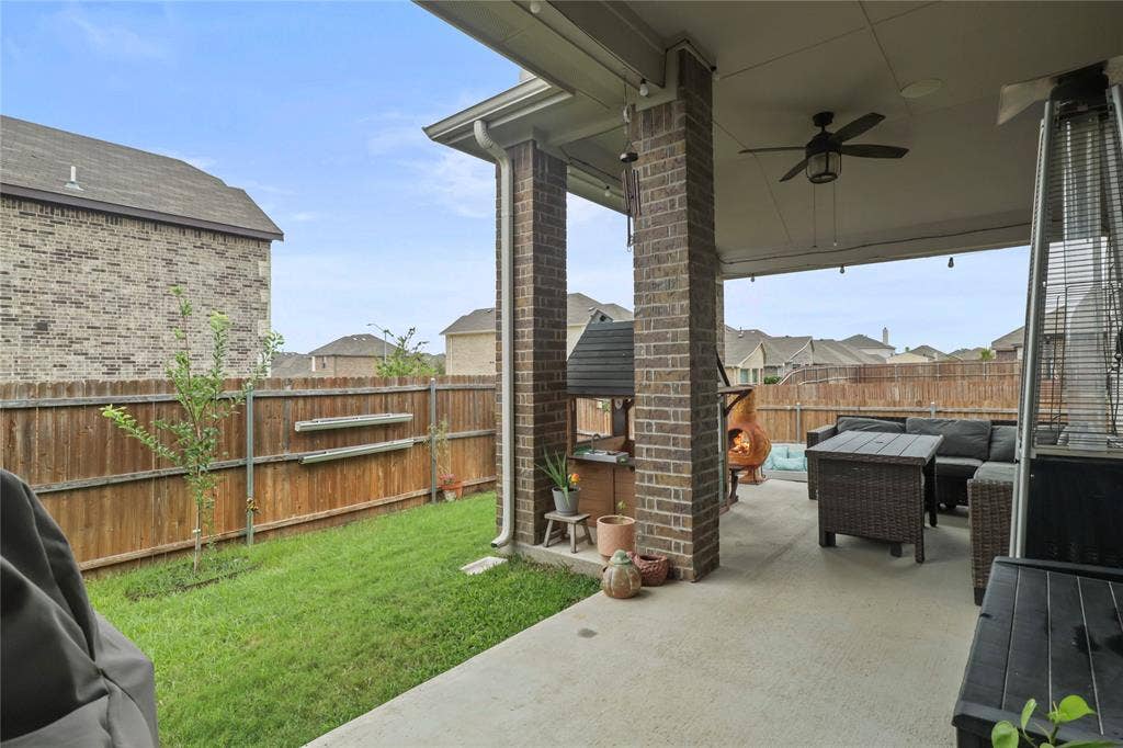 6152 Cobbetts Pond Lane, Fort Worth, TX 76179 Covered patio with brick columns, concrete flooring, and ceiling fan
