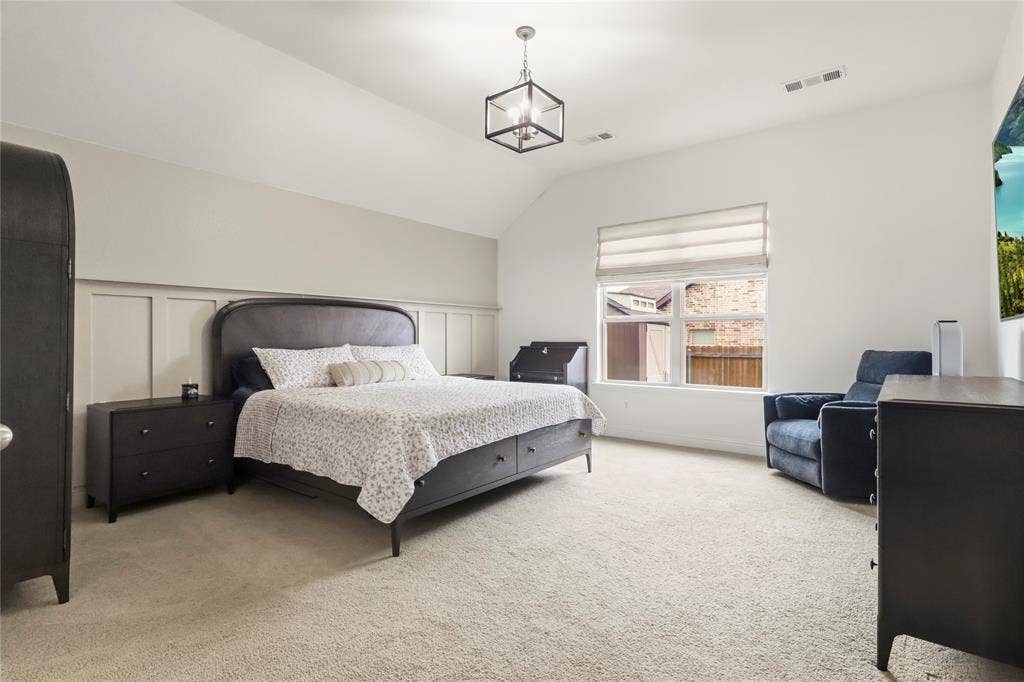 6152 Cobbetts Pond Lane, Fort Worth, TX 76179 Vaulted ceiling with an overhead light fixture, board and batten wall detailing, large window with shades, and plush carpeting