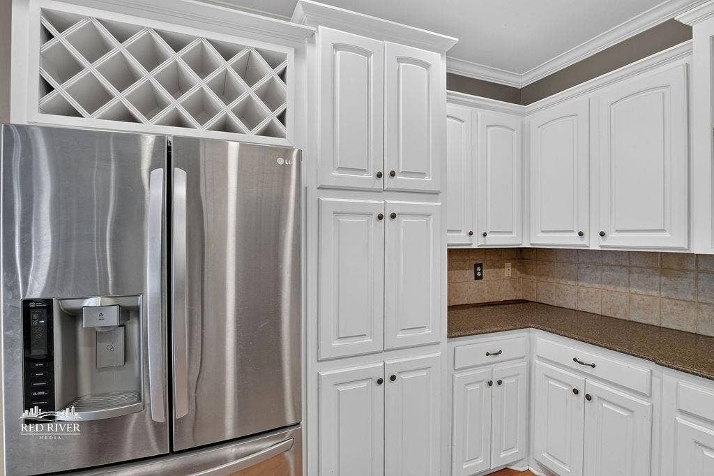 10571 Norris Ferry Road, Shreveport, LA 71106 Wine rack above refrigerator.