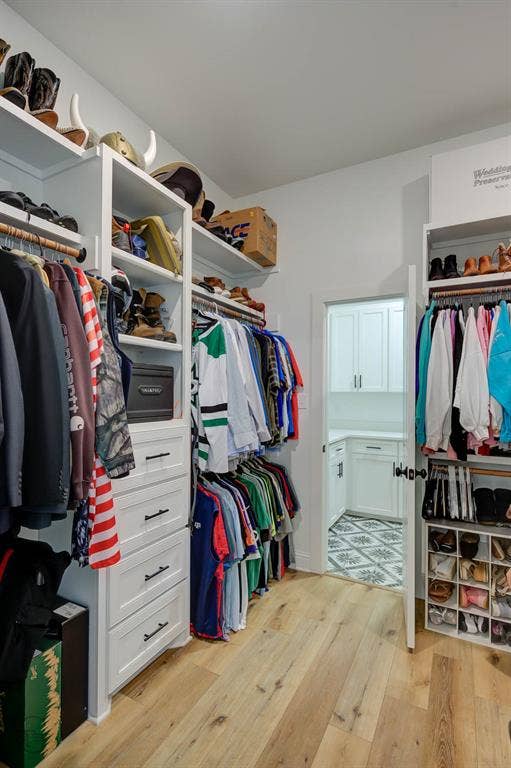 Custom closet system with built-in shelving, hanging rods, and integrated drawer storage
