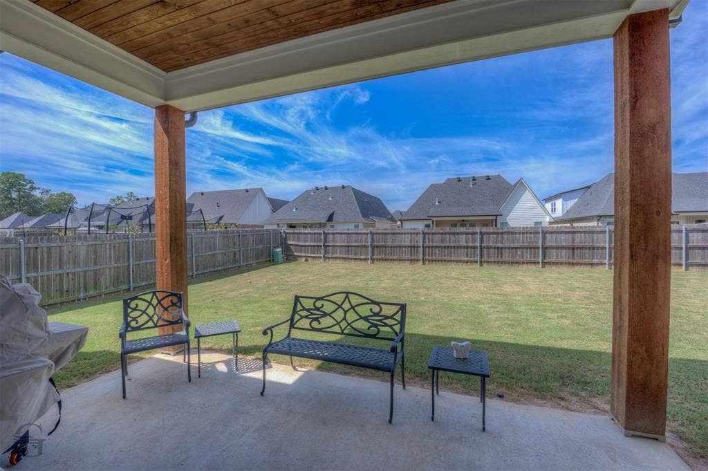 Covered patio featuring wood-finish ceiling and structural posts