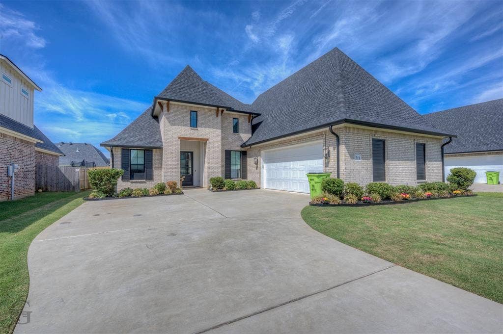 Brick exterior with dark shingle roofing