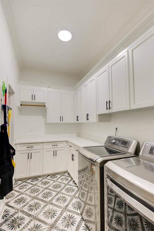 White cabinetry with black hardware, extensive countertop space, patterned floor tiles, built-in recessed lighting, and crown molding