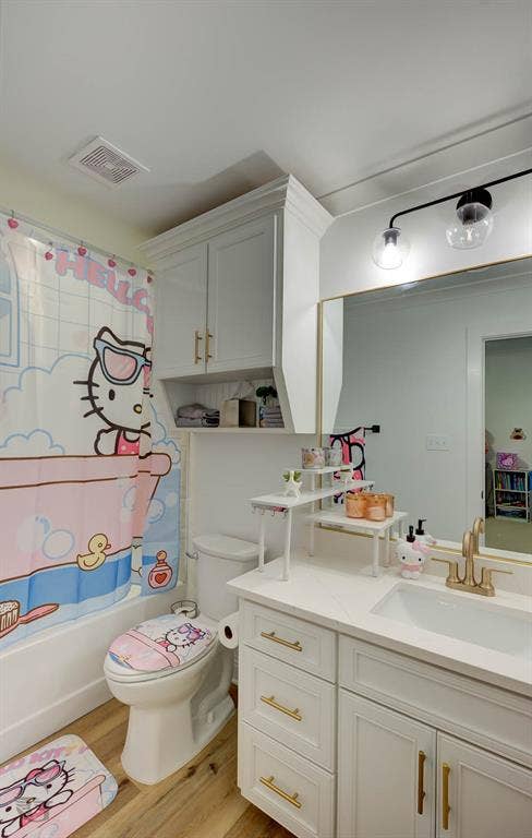 White vanity with gold-finish hardware, integrated sink, and white countertop