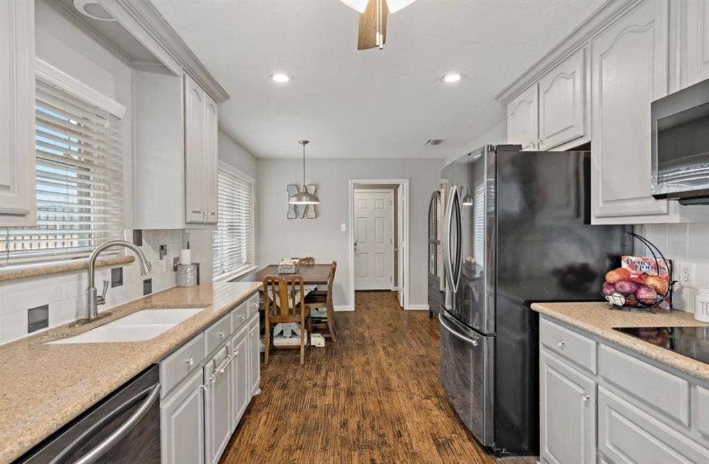 1603 Vicksburg Drive, Sachse, TX 75048 Kitchen featuring tasteful backsplash, dark wood-style floors, stainless steel appliances, a sink, and recessed lighting