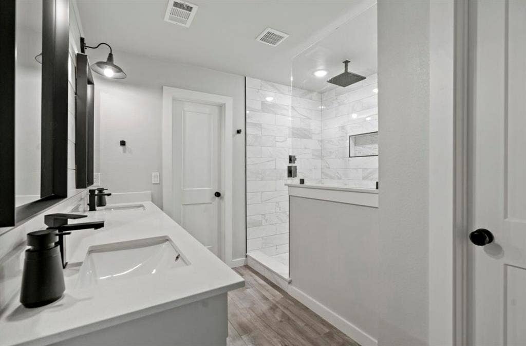 1603 Vicksburg Drive, Sachse, TX 75048 Bathroom featuring visible vents, a sink, and wood finished floors