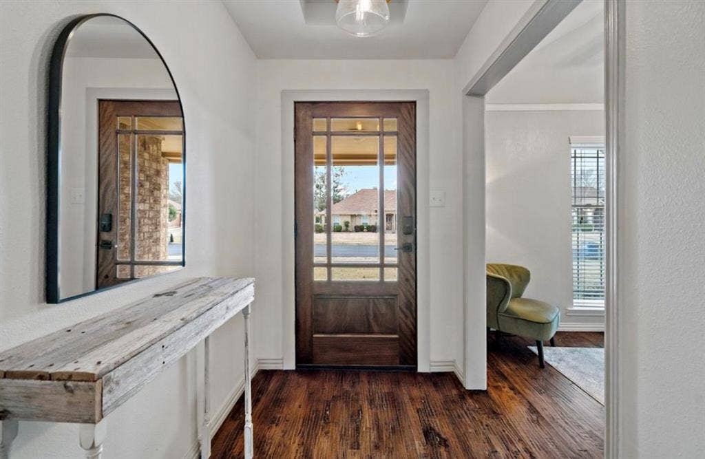 1603 Vicksburg Drive, Sachse, TX 75048 Entrance foyer with dark wood-style flooring and baseboards