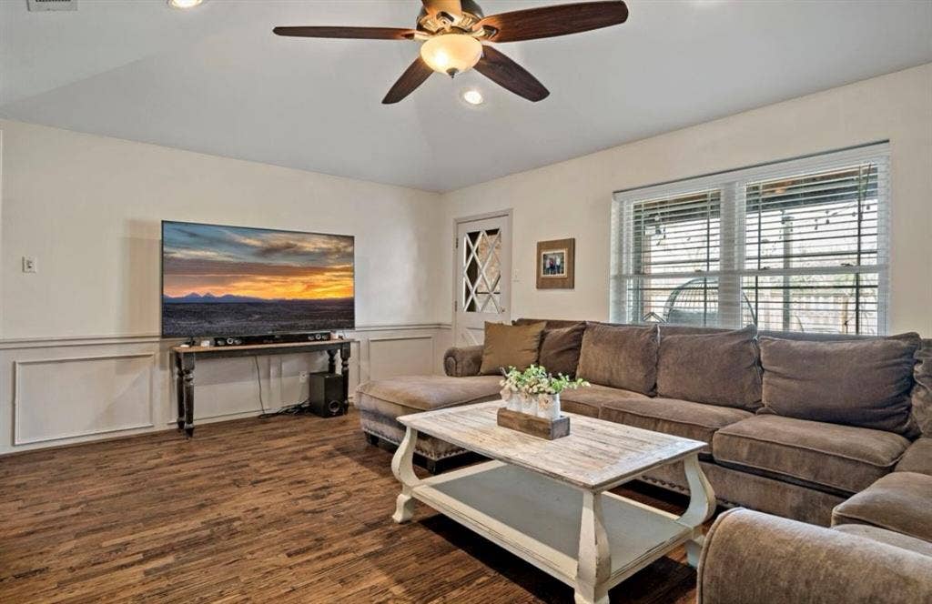 1603 Vicksburg Drive, Sachse, TX 75048 Living room featuring dark wood-style floors, recessed lighting, a wainscoted wall, and a ceiling fan