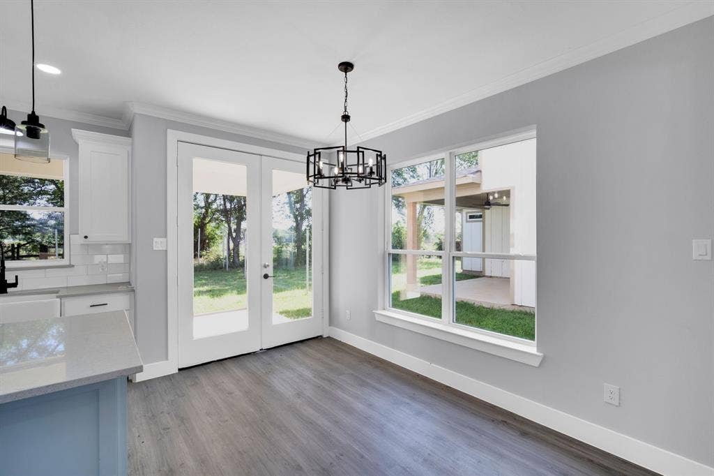 1995 Lakeview Drive, Kemp, TX 75143 Wood-finish flooring, white French doors, large windows, recessed ceiling lighting, and a contemporary chandelier