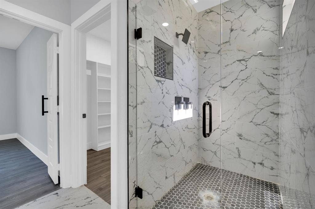 1995 Lakeview Drive, Kemp, TX 75143 Walk-in shower featuring a glass enclosure, a rain showerhead, a tile niche, and hexagonal tile flooring