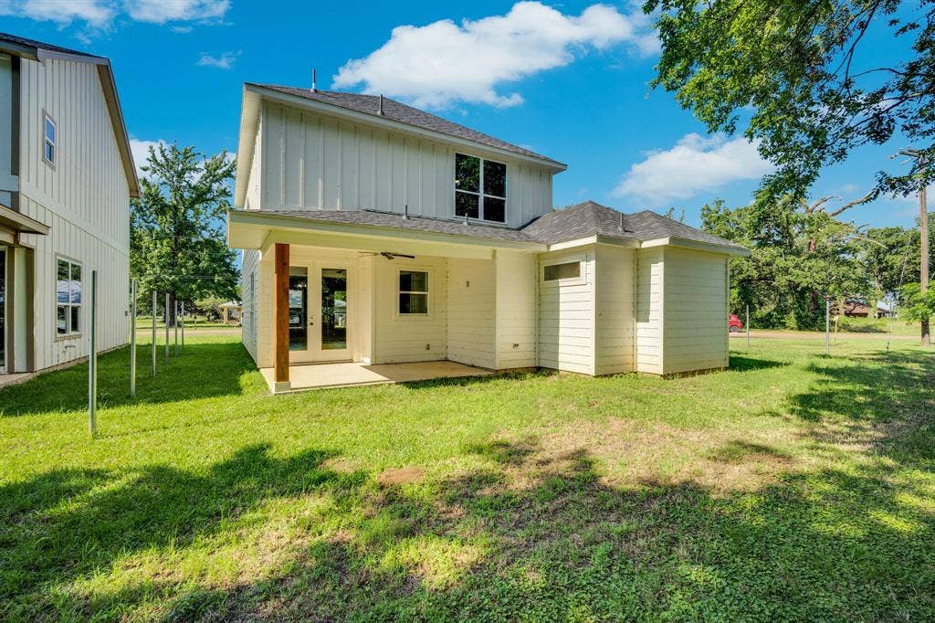 1995 Lakeview Drive, Kemp, TX 75143 Rear exterior featuring board and batten siding, a covered patio with a wood-finish column, and double glass panel doors