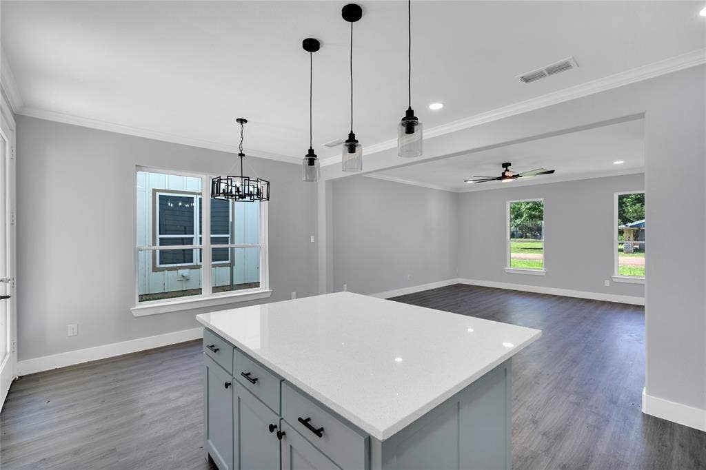 1995 Lakeview Drive, Kemp, TX 75143 Kitchen island featuring a white countertop and light blue cabinetry, with wood-finish flooring throughout