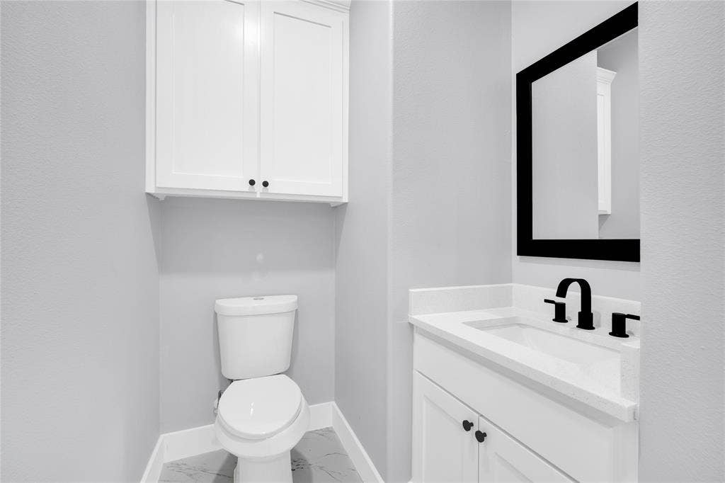 1995 Lakeview Drive, Kemp, TX 75143 White vanity with an integrated sink and matte black faucet