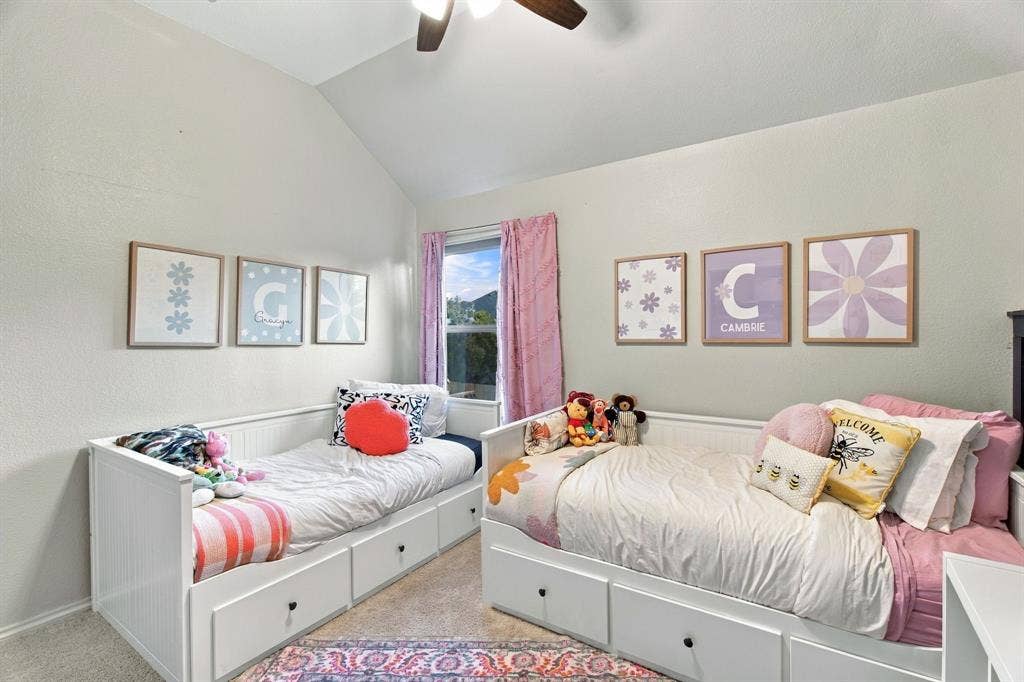 Vaulted ceilings, neutral wall tones, window with natural lighting, and overhead ceiling fan