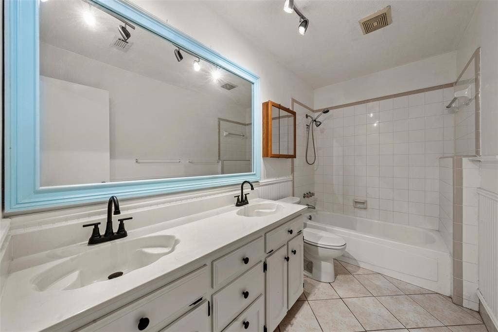 812 Regina Drive, Hewitt, TX 76643 Double vanity with integrated sinks, matte black faucets, and track lighting