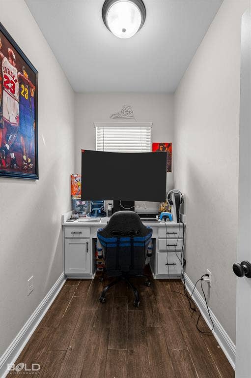 Dedicated workspace featuring wood-finish flooring and a built-in desk with cabinet storage and drawers
