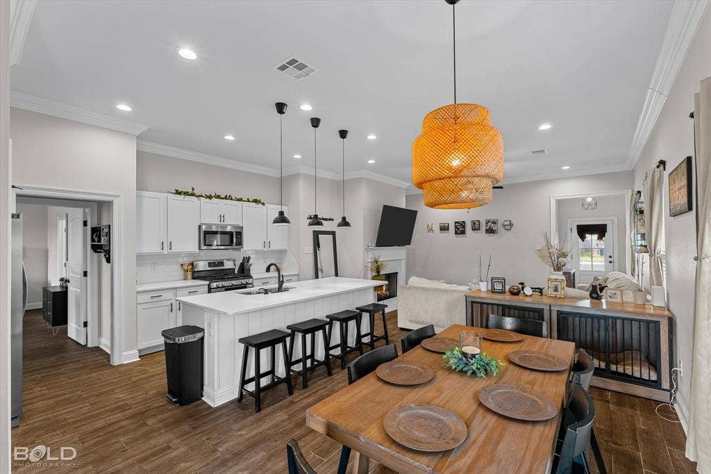 Open-concept living area with wood-finish flooring