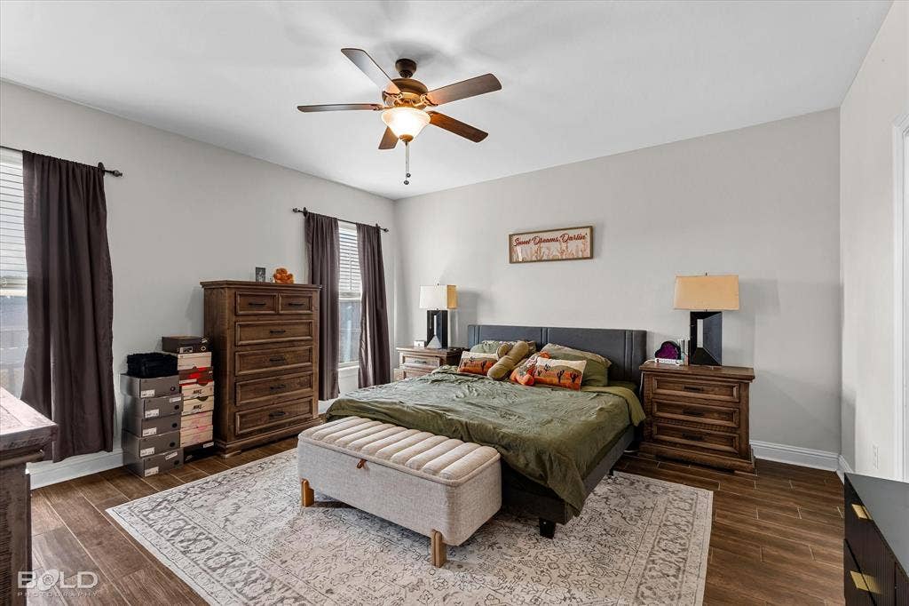 Wood-finish flooring with a ceiling fan light fixture