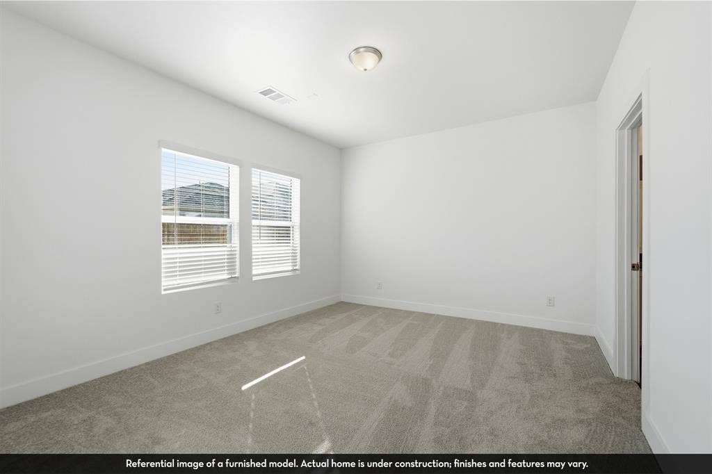 5218 Noland Drive, Princeton, TX 75071 Neutral-toned wall-to-wall carpeting, dual windows with horizontal blinds, and a flush-mount overhead light fixture