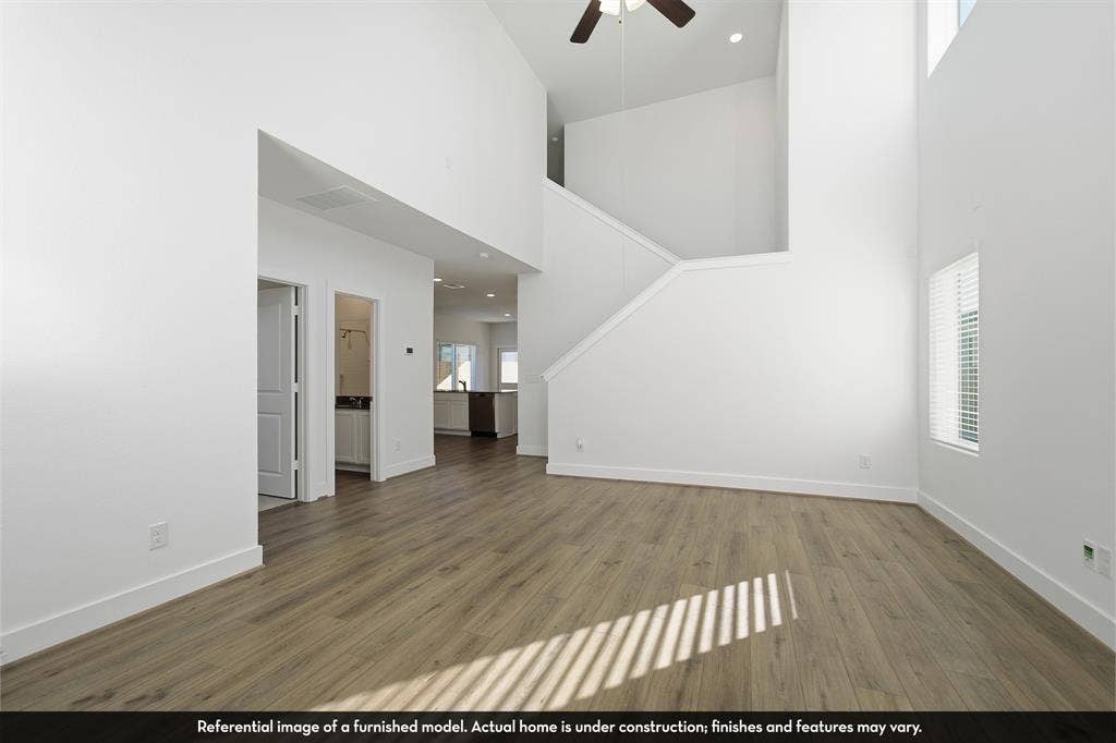 5218 Noland Drive, Princeton, TX 75071 Double-height ceilings, wood-finish flooring, recessed lighting, and a ceiling fan