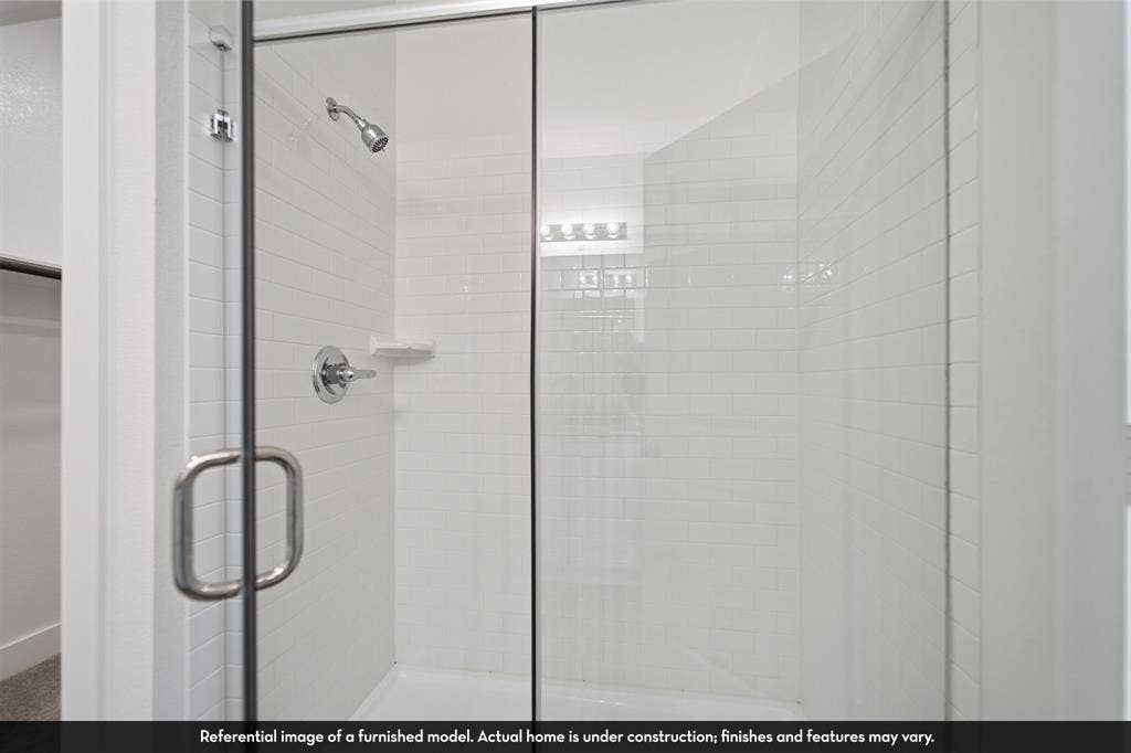 5218 Noland Drive, Princeton, TX 75071 Walk-in shower featuring subway tile surround, frameless glass enclosure, built-in soap niche, and chrome hardware
