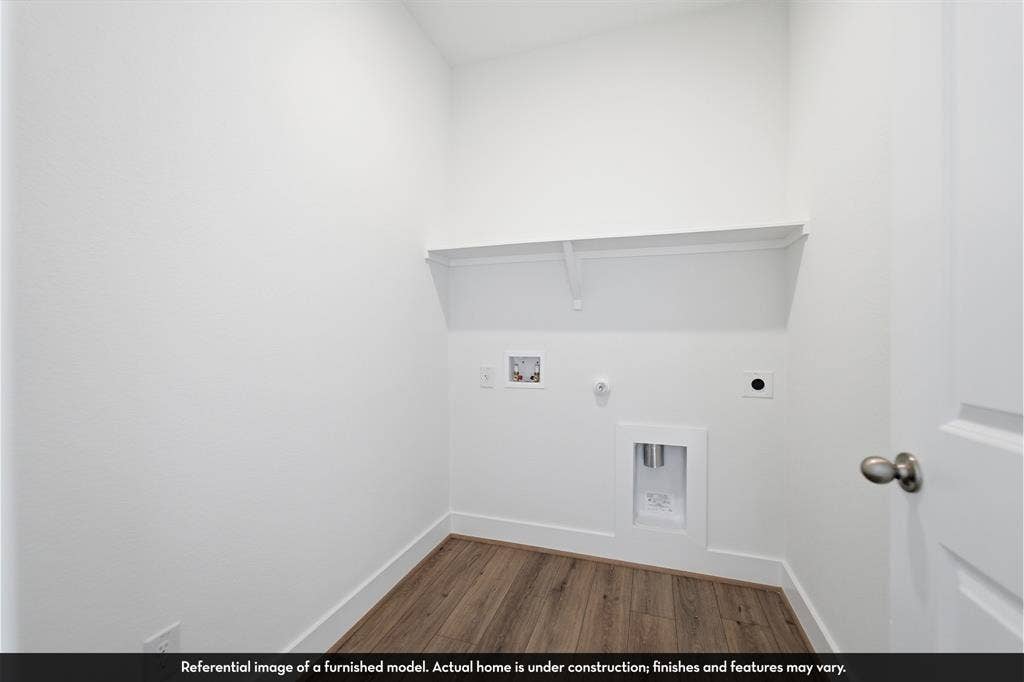 5218 Noland Drive, Princeton, TX 75071 Utility area featuring wood-finish flooring, a built-in wall shelf, and laundry hookups