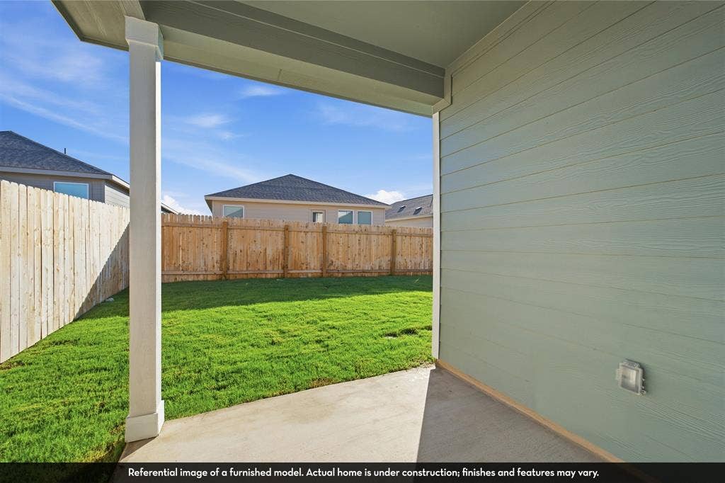 5218 Noland Drive, Princeton, TX 75071 Covered concrete patio with horizontal lap siding, square support column, and wood privacy fencing enclosing a grass lawn