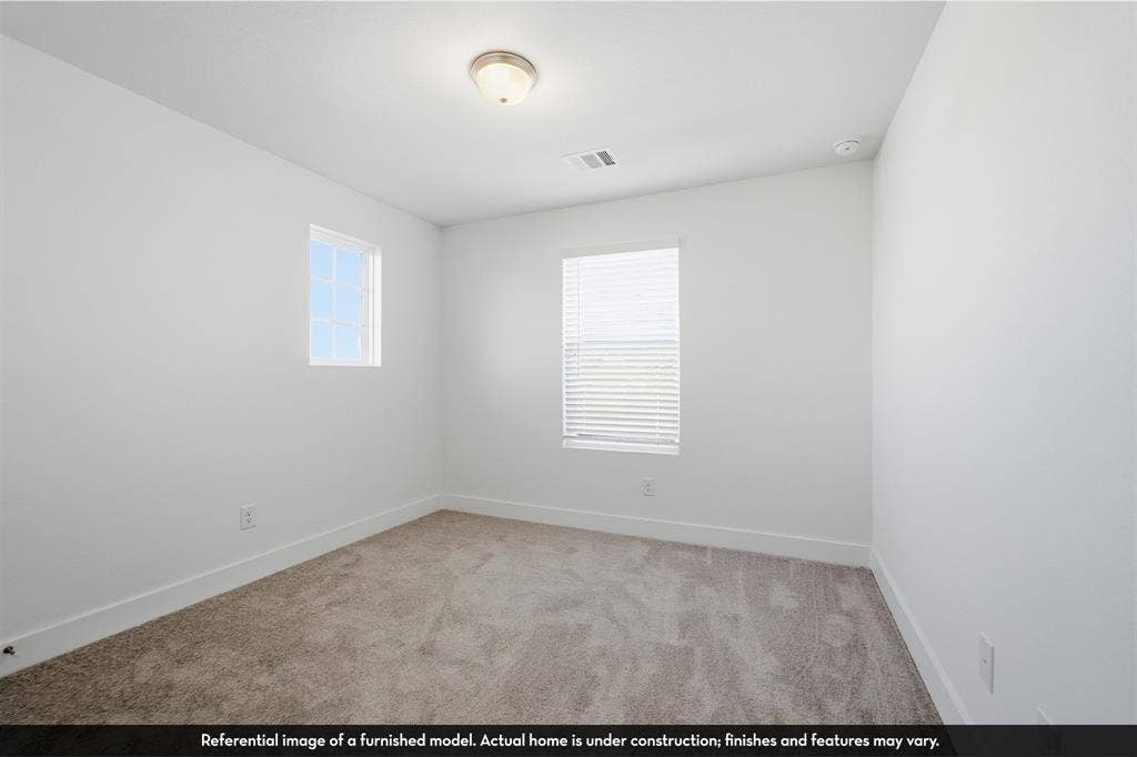 5218 Noland Drive, Princeton, TX 75071 Neutral interior space featuring high-pile wall-to-wall carpeting, two multi-pane windows, and a flush-mount ceiling light fixture
