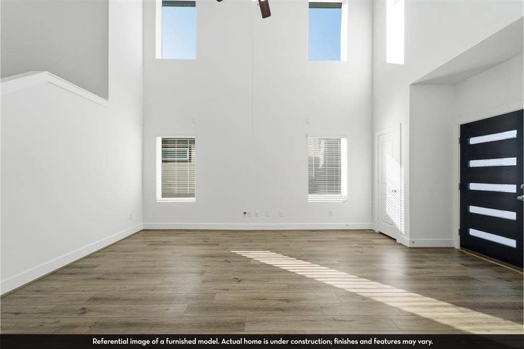 821 Whitmore Drive, Princeton, TX 75071 Double-height ceiling, wood-finish flooring, multi-paneled front door with glass inserts, and large windows
