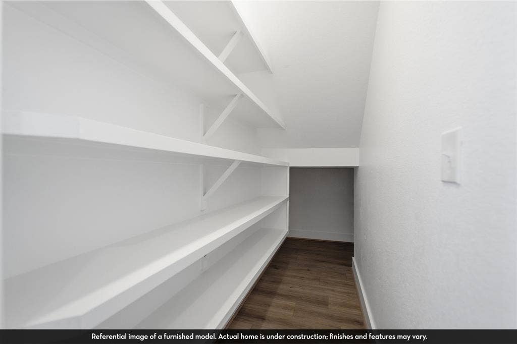 821 Whitmore Drive, Princeton, TX 75071 Storage area featuring white built-in shelving and wood-finish flooring